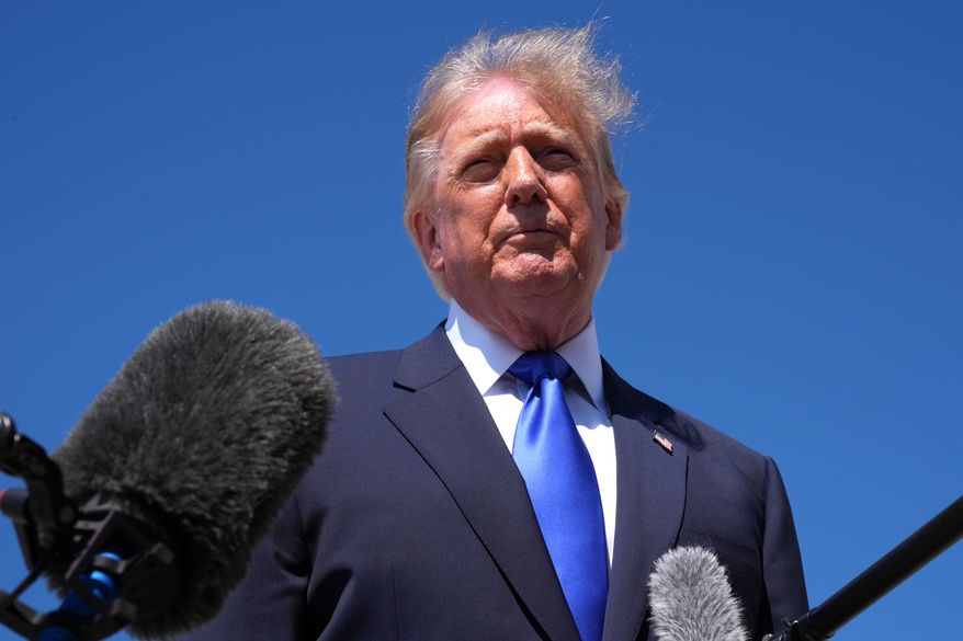 President Donald Trump talks with reporters after an emergency inflatable slide deployed on Air Force One before before Trump arrived to board at Joint Base Andrews, Md., Wednesday, Sept. 9, 2026. (AP Photo/Jacquelyn Martin)