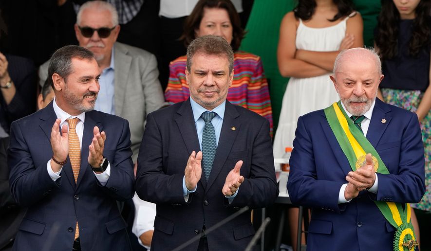 Federal Police Director-General Andrei Rodrigues, left, applauds with Brazilian President Luiz Inacio Lula da Silva, right, and Justice Minister Wellington Cesar during Independence Day celebrations in Brasilia, Brazil, Monday, Sept. 7, 2026. (AP Photo/Eraldo Peres)