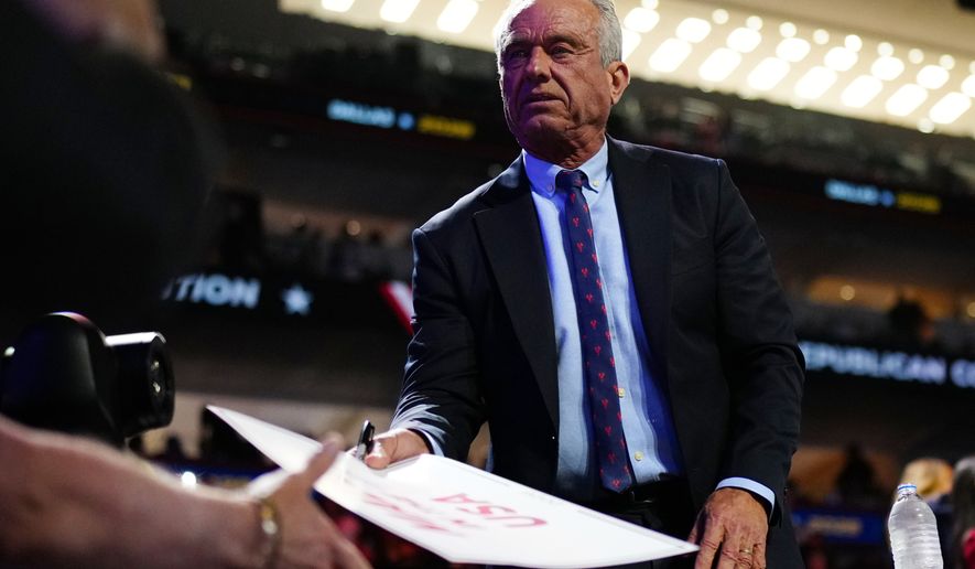 Health and Human Services Secretary Robert F. Kennedy Jr. signs autographs at the Republican convention, Wednesday, Sept. 9, 2026, in Dallas. (AP Photo/Julia Demaree Nikhinson)