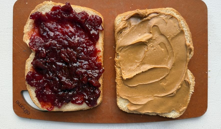 A peanut butter and jelly sandwich is prepared in New York in August 2026. (Katie Workman via AP)