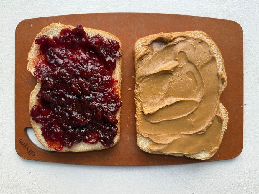 A peanut butter and jelly sandwich is prepared in New York in August 2026. (Katie Workman via AP)