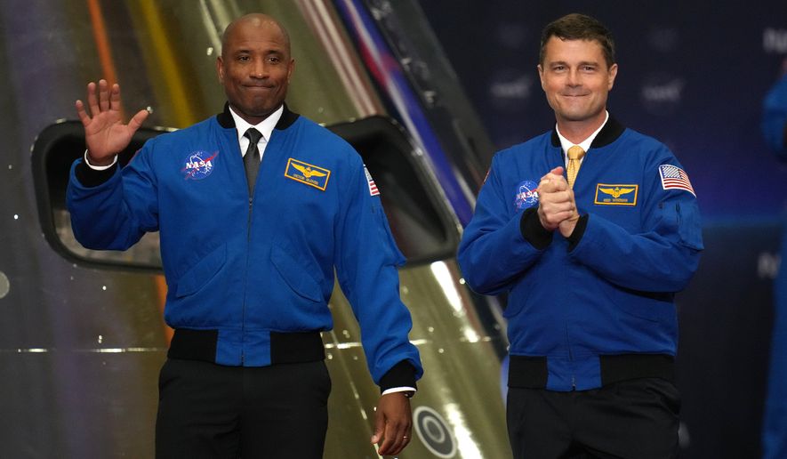 FILE - Artemis II Pilot Victor Glover, left, and Commander Reid Wiseman, right, participate in a Congressional Space Medal of Honor ceremony at NASA's Johnson Space Center, Aug. 28, 2026, in Houston. (AP Photo/Karen Warren, file)