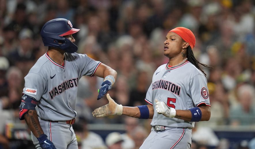 Washington Nationals' CJ Abrams, right, celebrates with teammate Daylen Lile after scoring on a two-RBI double by Brady House during the sixth inning of a baseball game Tuesday, Sept. 8, 2026, in San Diego. (AP Photo/Gregory Bull)