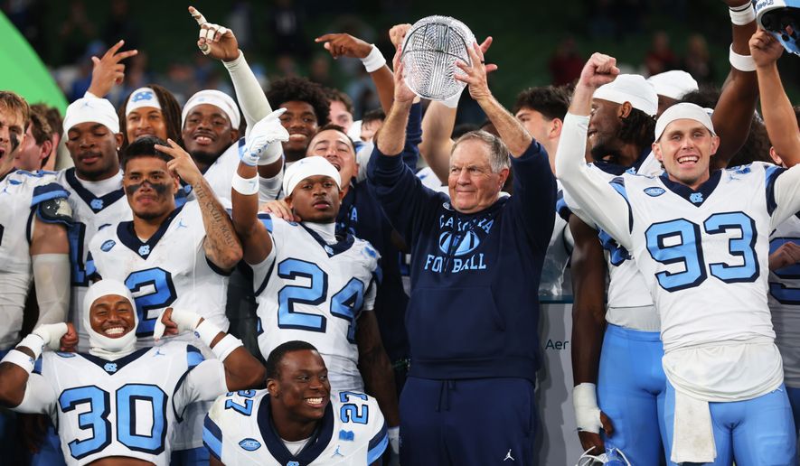 North Carolina head coach Bill Belichick, center right, and his team celebrate after defeating TCU in an NCAA college football game in Dublin, Ireland, Saturday, Aug. 29, 2026. (AP Photo/Peter Morrison)