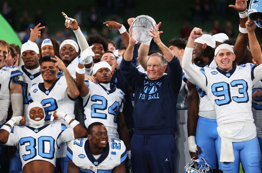 North Carolina head coach Bill Belichick, center right, and his team celebrate after defeating TCU in an NCAA college football game in Dublin, Ireland, Saturday, Aug. 29, 2026. (AP Photo/Peter Morrison)