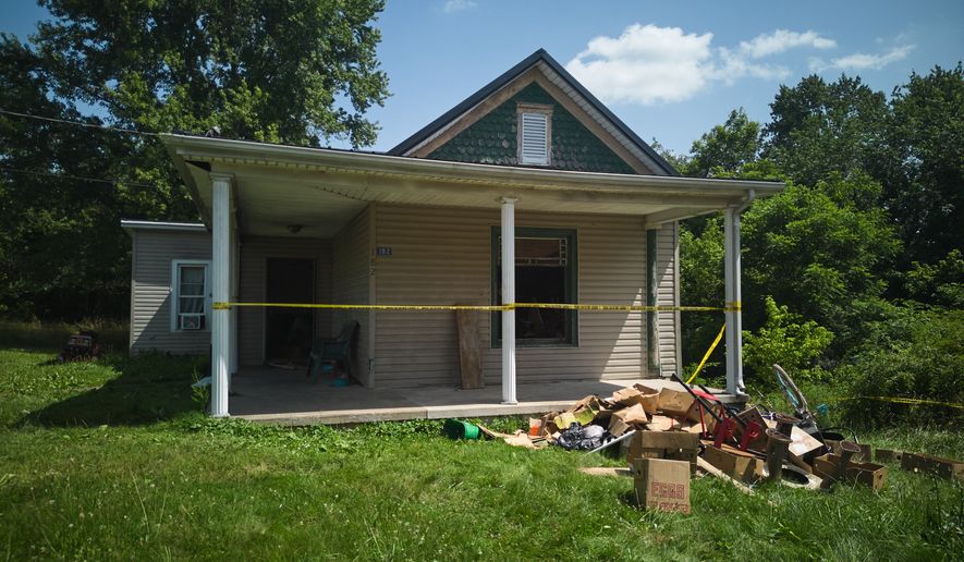 FILE - Police tape surrounds a home where authorities say they removed 16 children and arrested four adults in Hamden, Ohio, July 1, 2026. (AP Photo/Carolyn Kaster, File)
