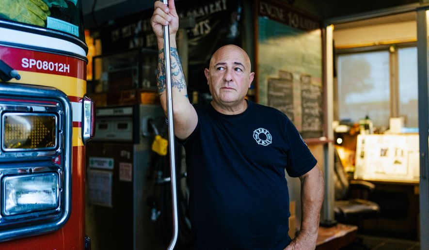 Firefighter Sal Argano, Ladder 10, poses for a portrait at FDNY "Ten House" near Ground Zero on Friday, Aug. 7, 2026, in New York. (AP Photo/Angelina Katsanis)