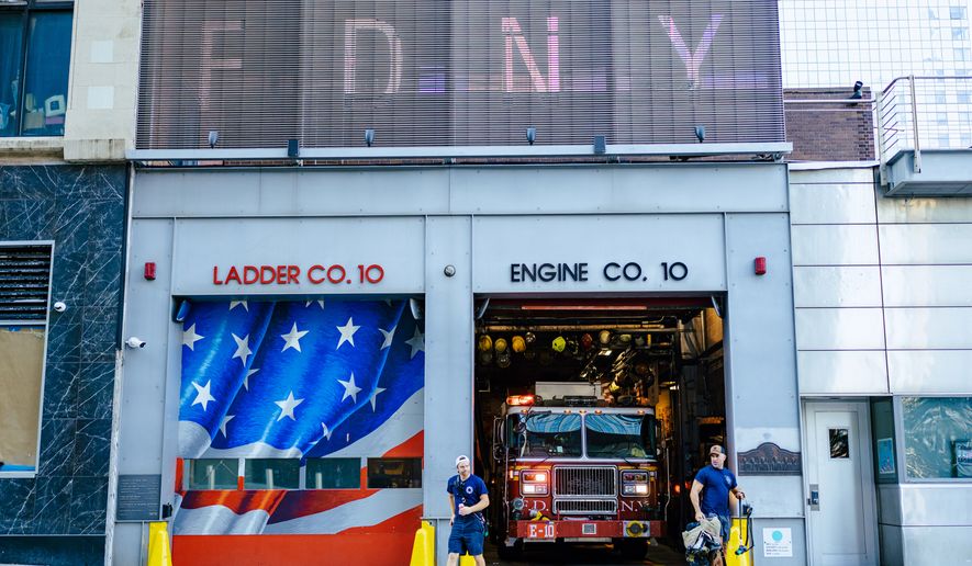 FDNY "Ten House" firefighters work near Ground Zero, 25 years after the Sept. 11, 2001, attacks, on Friday, Aug. 7, 2026 in New York. (AP Photo/Angelina Katsanis)