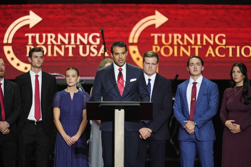 Andrew Kolvet, center, speaks at a memorial for conservative activist Charlie Kirk, Sunday, Sept. 21, 2025, at State Farm Stadium in Glendale, Ariz. (AP Photo/John Locher)