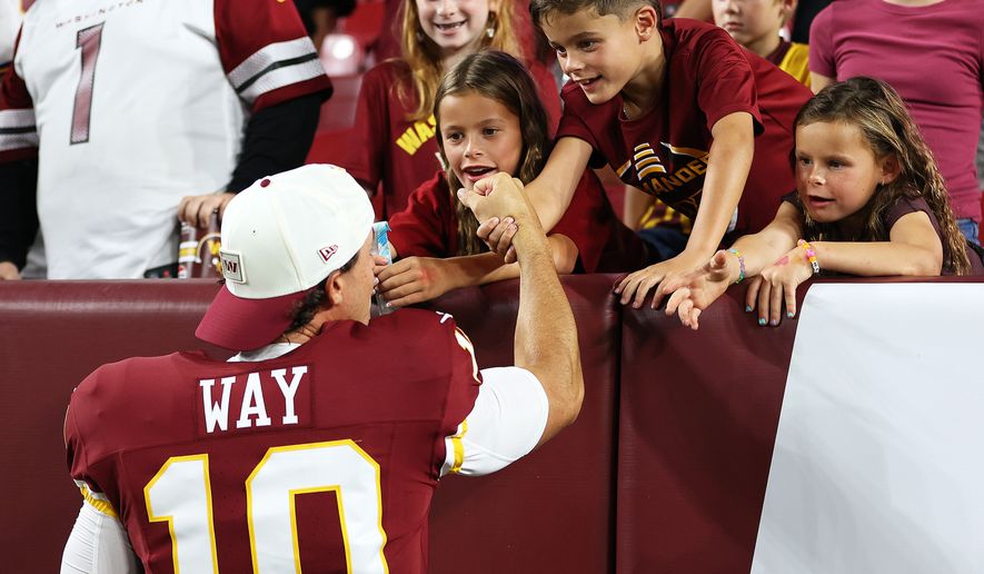 Washington Commanders punter Tress Way (10) greets fans after an NFL football game against the Miami Dolphins, Friday, Aug. 14, 2026 in Landover, Md. (AP Photo/Daniel Kucin Jr.)