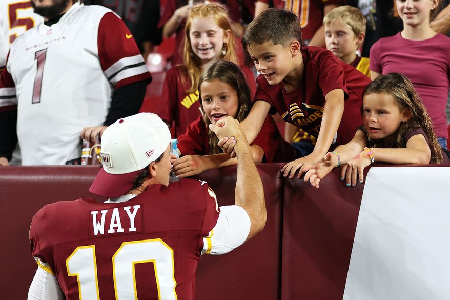 Washington Commanders punter Tress Way (10) greets fans after an NFL football game against the Miami Dolphins, Friday, Aug. 14, 2026 in Landover, Md. (AP Photo/Daniel Kucin Jr.)
