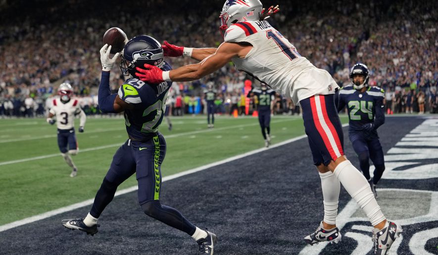 Seattle Seahawks cornerback Josh Jobe (29) intercepts a pass in the end zone intended for New England Patriots wide receiver Mack Hollins (13) during the second half of an NFL football game, Wednesday, Sept. 9, 2026, in Seattle. (AP Photo/Stephen Brashear)