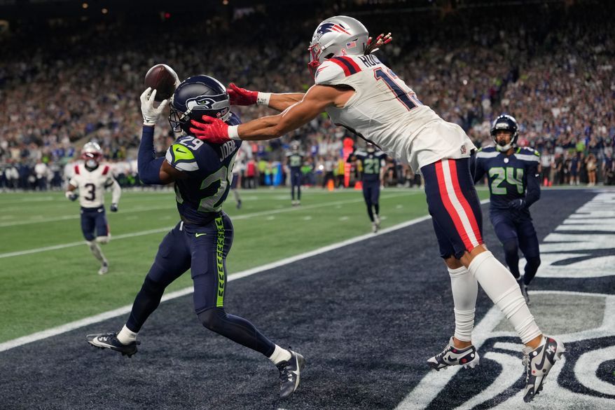 Seattle Seahawks cornerback Josh Jobe (29) intercepts a pass in the end zone intended for New England Patriots wide receiver Mack Hollins (13) during the second half of an NFL football game, Wednesday, Sept. 9, 2026, in Seattle. (AP Photo/Stephen Brashear)