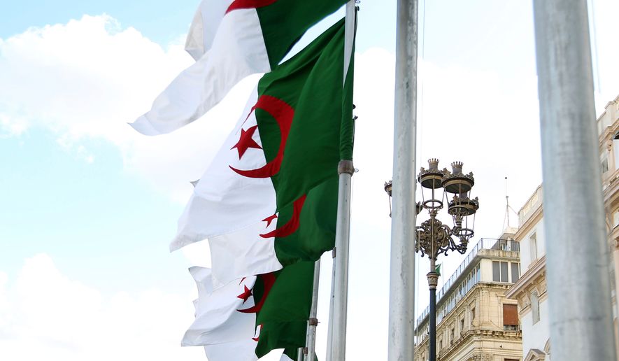 FILE - Algeria's flags fly Wednesday, April 16, 2025 in Algiers. (AP Photo/Fateh Guidoum, File)