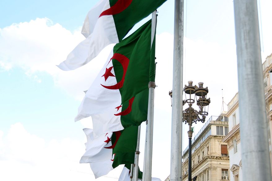 FILE - Algeria's flags fly Wednesday, April 16, 2025 in Algiers. (AP Photo/Fateh Guidoum, File)