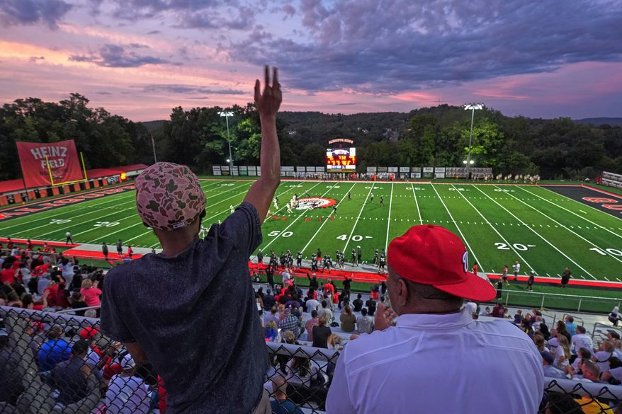 Aliquippa High School football fans cheer during a high school football game between Aliquippa and Mars high schools at Heinz Field in Aliquippa, Pa., Friday, Sept. 4, 2026. (AP Photo/Gene J. Puskar)