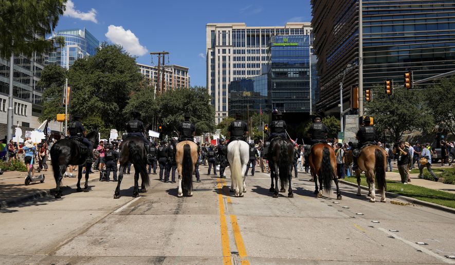 Dallas Police's Mounted Unit block protesters at the Dallas March on the RNC Midterm Convention in Dallas on Thursday, Sept. 10, 2026. (AP Photo/Gabriela Passos)
