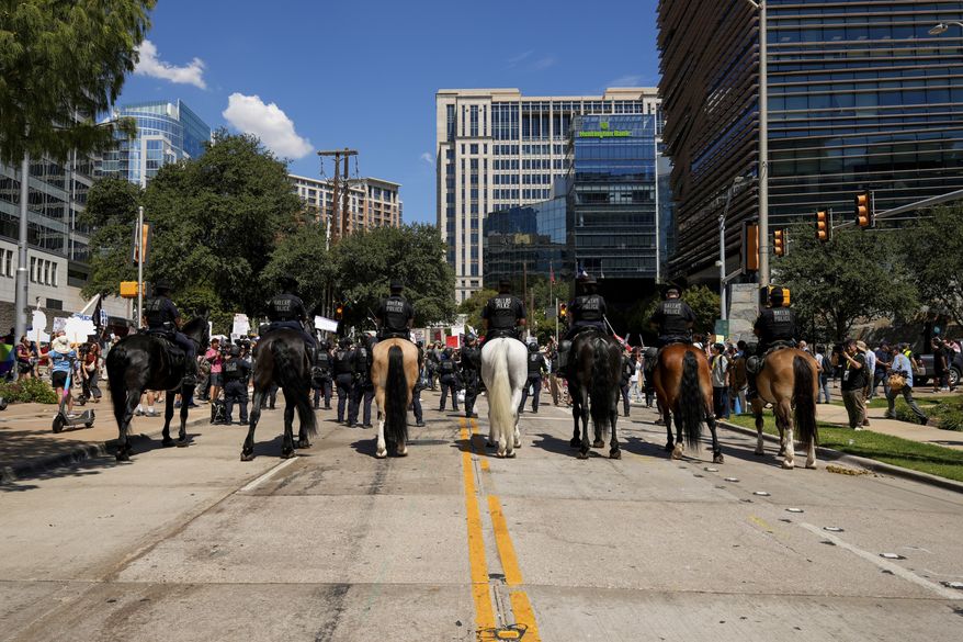 Dallas Police's Mounted Unit block protesters at the Dallas March on the RNC Midterm Convention in Dallas on Thursday, Sept. 10, 2026. (AP Photo/Gabriela Passos)