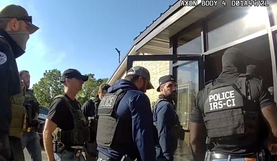 This image from Homeland Security Investigations body camera video shows federal authorities entering the Nutrition Bar Confectioners plant in Cato, N.Y., Sept. 4, 2025. (Homeland Security Investigations via AP)
