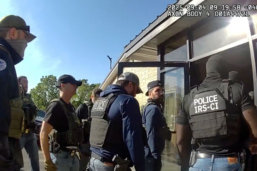 This image from Homeland Security Investigations body camera video shows federal authorities entering the Nutrition Bar Confectioners plant in Cato, N.Y., Sept. 4, 2025. (Homeland Security Investigations via AP)