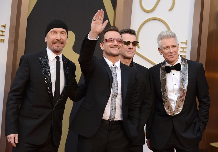 The Edge, from left, Bono, Larry Mullen, Jr., and Adam Clayton of U2 appear at the Oscars in Los Angeles on March 2, 2014. (Photo by Jordan Strauss/Invision/AP, File)
