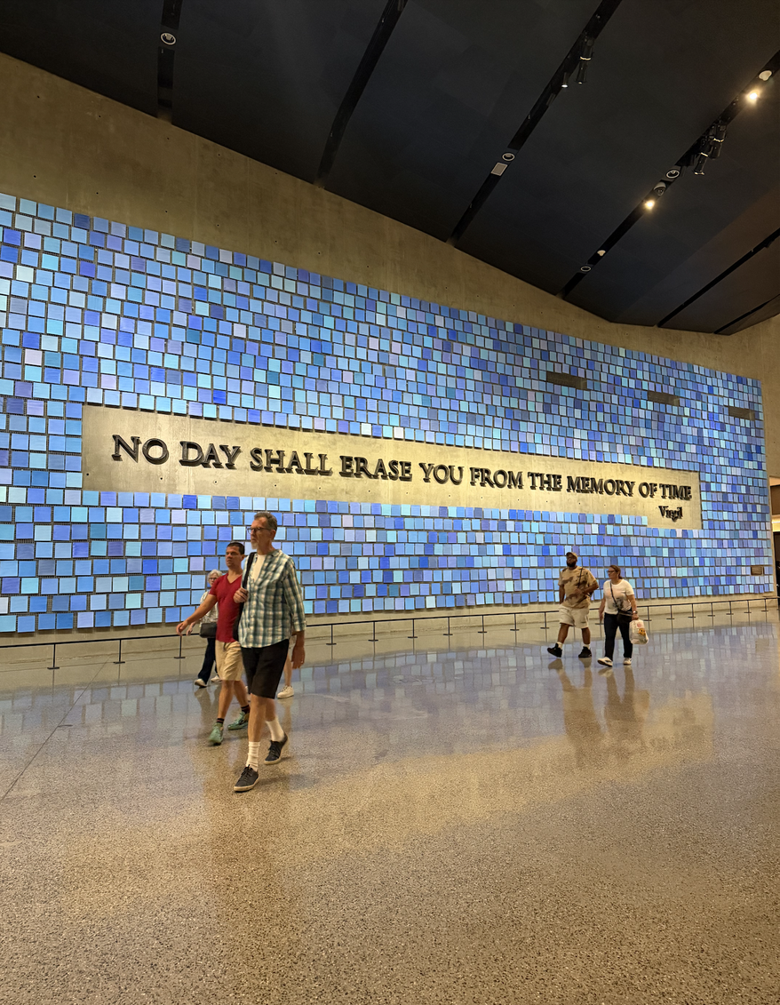 "No Day Shall Erase You From The Memory of Time" is pictured in front of a wall housing the unidentified remains of victims from the Sept. 11, 2001, and 1993 World Trade Center terrorist attacks in New York. Each blue tile represents a life lost on 9/11. (Juliet La Sala/The Washington Times)