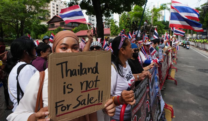 Protesters holding signs attend a demonstration demanding an end to alleged land-grabbing by foreigners, in front of Israeli Embassy in Bangkok, Thailand, Thursday, Sept. 10, 2026. (AP Photo/Sakchai Lalit)