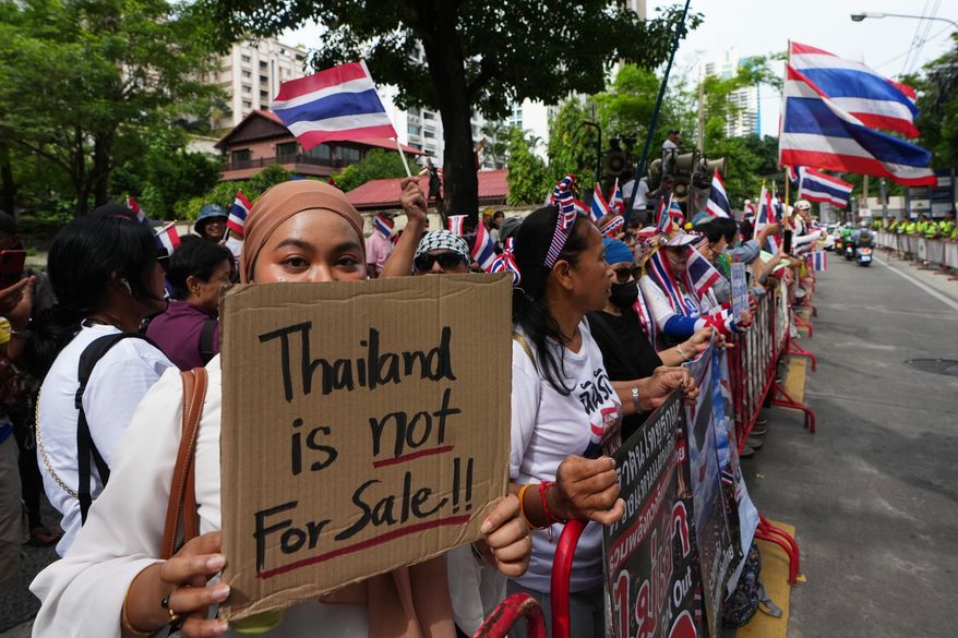 Protesters holding signs attend a demonstration demanding an end to alleged land-grabbing by foreigners, in front of Israeli Embassy in Bangkok, Thailand, Thursday, Sept. 10, 2026. (AP Photo/Sakchai Lalit)