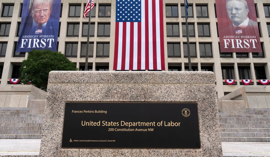 FILE - Portraits of Presidents Donald Trump and Theodore Roosevelt hang above the Department of Labor in Washington, July 7, 2026. (AP Photo/J. Scott Applewhite, File)