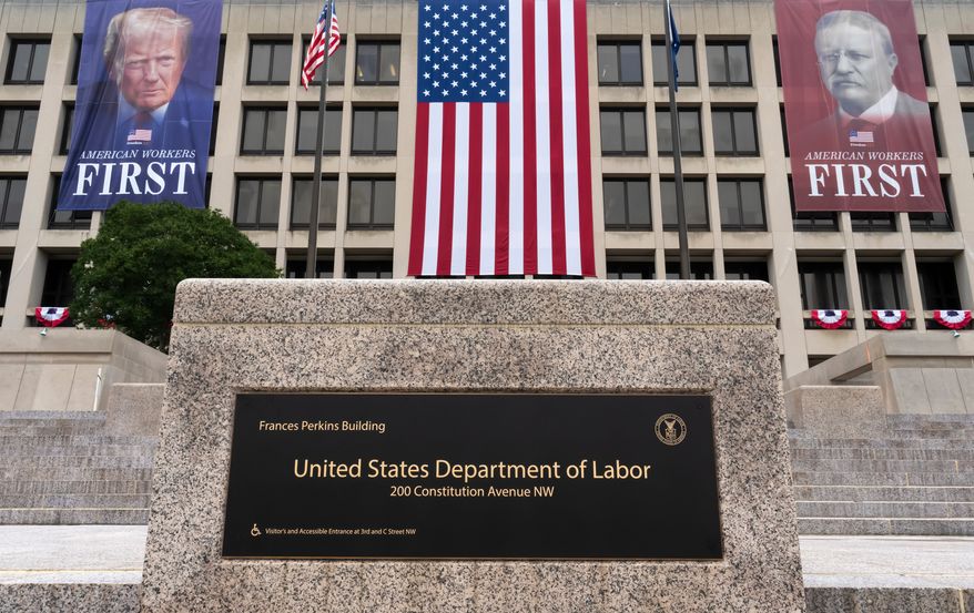 FILE - Portraits of Presidents Donald Trump and Theodore Roosevelt hang above the Department of Labor in Washington, July 7, 2026. (AP Photo/J. Scott Applewhite, File)