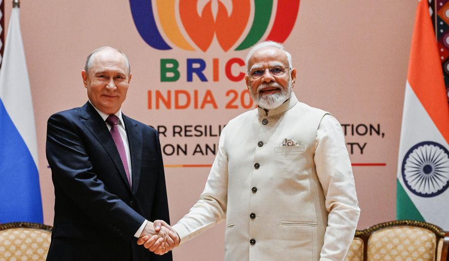 Russian President Vladimir Putin, left, and Indian Prime Minister Narendra Modi pose for a photo during their meeting on the sidelines of the BRICS Summit in New Delhi, India, on Friday, Sept. 11, 2026. (Kristina Solovyova, Sputnik, Kremlin Pool Photo via AP)