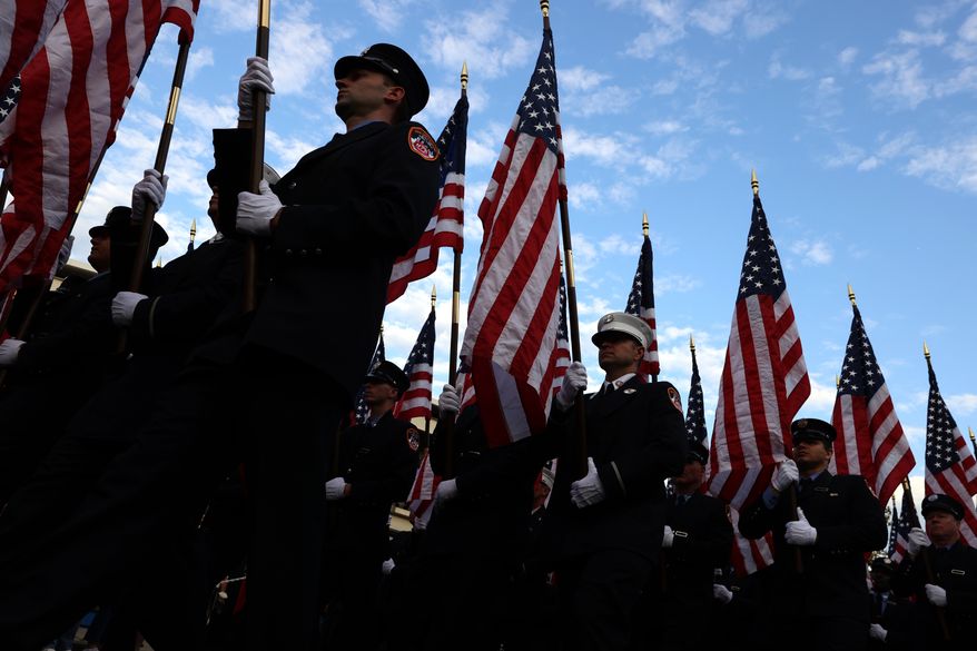 Members of the FDNY march with flags during a memorial to commemorate the 25th anniversary of the 9/11 attacks, Wednesday, Sept. 9, 2026, in the Staten Island borough of New York. (AP Photo/Pamela Smith)