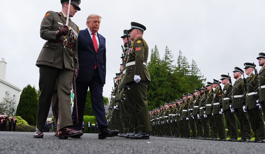 U.S. President Donald Trump, center, during a review of soldiers from the Guard of Honor during a visit with Ireland's President Catherine Connolly at Áras an Uachtaráin in Dublin, Saturday, Sept. 12, 2026. (AP Photo/Julia Demaree Nikhinson)