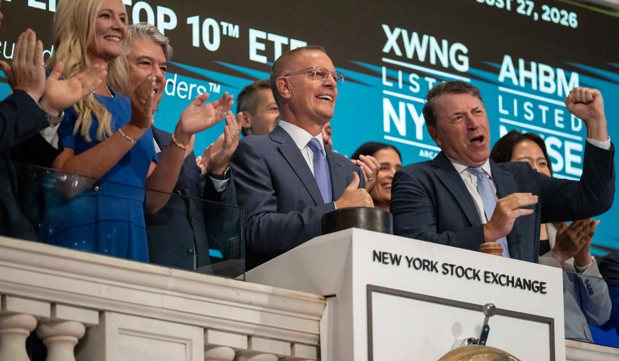 Christian Magoon, center, CEO of Amplify ETFs rings the opening bell on the floor of the New York Stock Exchange, Thursday, Aug. 27, 2026, in New York. (AP Photo/Yuki Iwamura)