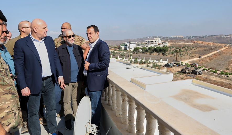 In this photo released by the Lebanese Presidency press office, Lebanese President Joseph Aoun, left, visits near the site where Israel captured a strategic hill earlier this month, in Zawtar al-Gharbieh, southern Lebanon, Saturday, Sept. 12, 2026. (Lebanese Presidency Press Office via AP)