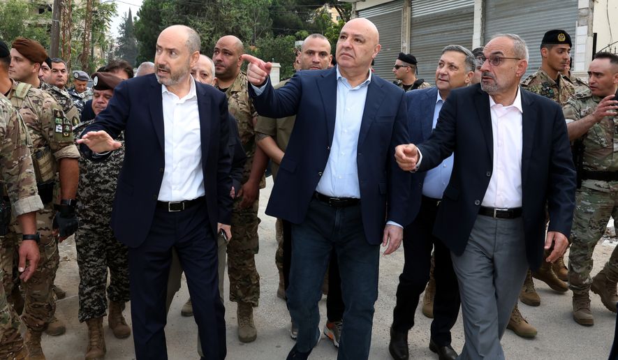 In this photo released by the Lebanese Presidency press office, Lebanese President Joseph Aoun, center, gestures during a visit near the site where Israel captured a strategic hill earlier this month, in the city of Nabatiyeh, southern Lebanon, Saturday, Sept. 12, 2026. (Lebanese Presidency Press Office via AP)