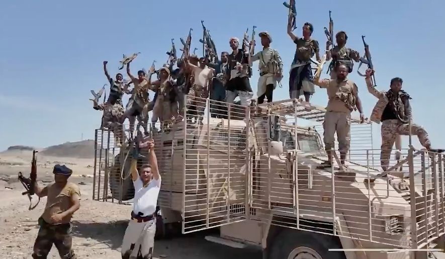 This image taken from undated video released by the Houthi-run Al-Masirah television channel on Saturday, Sept. 12, 2026, shows Houthi fighters chanting and raising rifles atop a military vehicle in Dhubab district, Taiz province, Yemen, according to the channel. (Al-Masirah TV via AP)