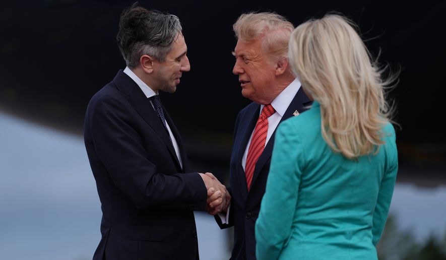 U.S. President Donald Trump, center, is greeted by Ireland's Finance Minister Simon Harris, left, during arrival at Dublin Airport in Dublin, Saturday, Sept. 12, 2026. (AP Photo/Julia Demaree Nikhinson)