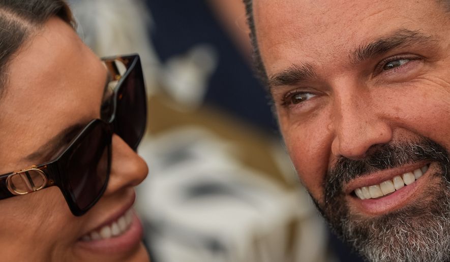Donald Trump Jr. and his wife Bettina Anderson look at each other while waiting for President Donald Trump to speak at Deerfield Residence, the residence of the U.S. Ambassador to Ireland Edward S. Walsh, Saturday, Sept. 12, 2026, in Dublin. (AP Photo/Julia Demaree Nikhinson)