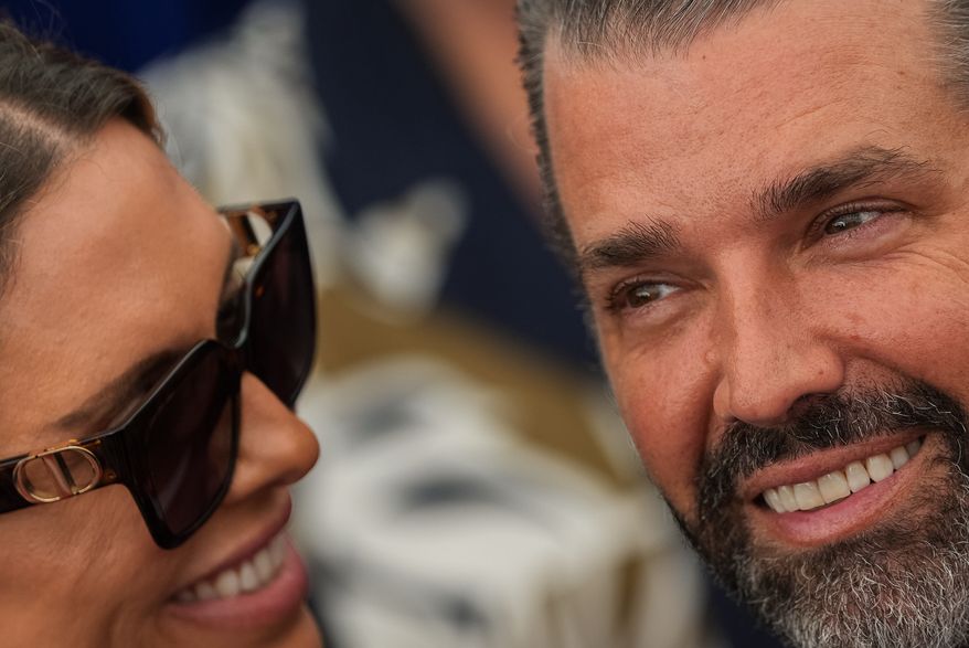 Donald Trump Jr. and his wife Bettina Anderson look at each other while waiting for President Donald Trump to speak at Deerfield Residence, the residence of the U.S. Ambassador to Ireland Edward S. Walsh, Saturday, Sept. 12, 2026, in Dublin. (AP Photo/Julia Demaree Nikhinson)