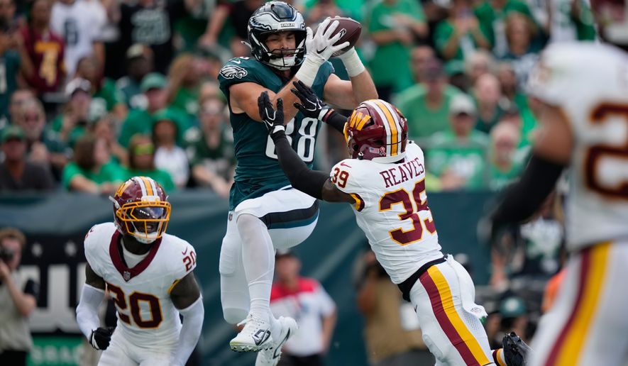 Philadelphia Eagles tight end Dallas Goedert (88) catches a pass over Washington Commanders safety Jeremy Reaves (39) for a touchdown during the first half of an NFL football game, Sunday, Sept. 13, 2026, in Philadelphia. (AP Photo/Matt Slocum)