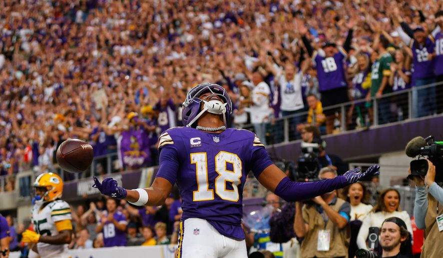 Minnesota Vikings wide receiver Justin Jefferson (18) celebrates after catching two-point conversion pass during the second half of an NFL football game against the Green Bay Packers, Sunday, Sept. 13, 2026, in Minneapolis, Minn. (AP Photo/Bailey Hillesheim)