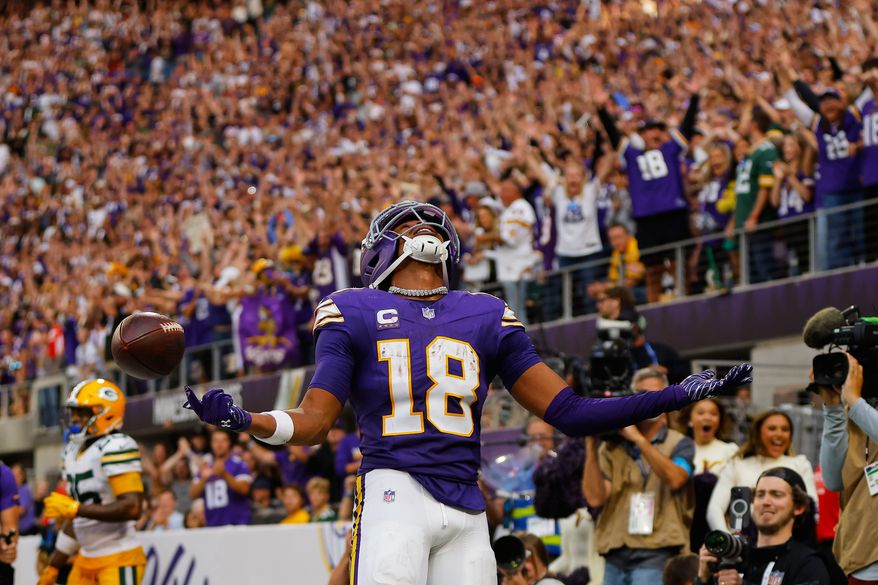 Minnesota Vikings wide receiver Justin Jefferson (18) celebrates after catching two-point conversion pass during the second half of an NFL football game against the Green Bay Packers, Sunday, Sept. 13, 2026, in Minneapolis, Minn. (AP Photo/Bailey Hillesheim)