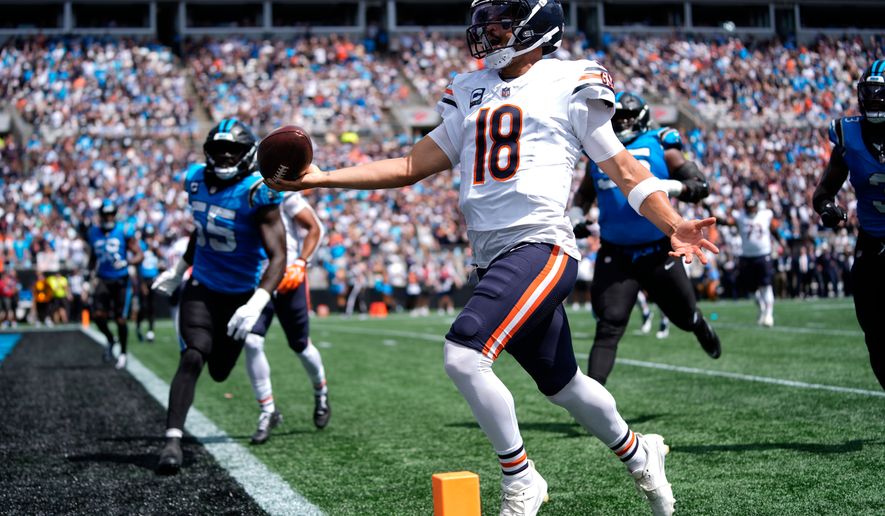 Chicago Bears quarterback Caleb Williams (18) runs to score a touchdown during the first half of an NFL football game, Sunday, Sept. 13, 2026, in Charlotte, N.C. (AP Photo/Erik Verduzco)