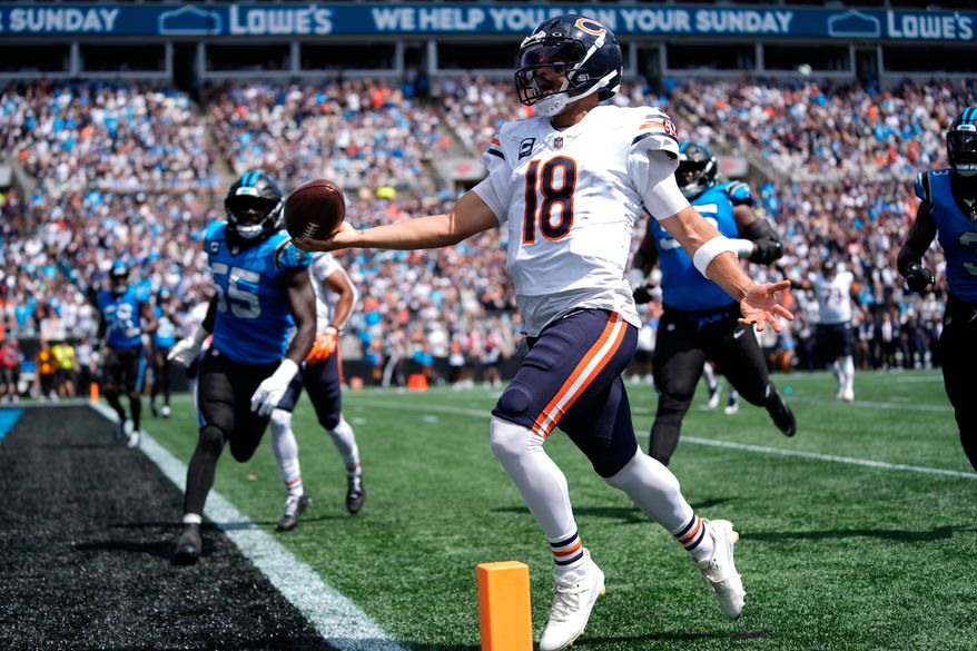 Chicago Bears quarterback Caleb Williams (18) runs to score a touchdown during the first half of an NFL football game, Sunday, Sept. 13, 2026, in Charlotte, N.C. (AP Photo/Erik Verduzco)