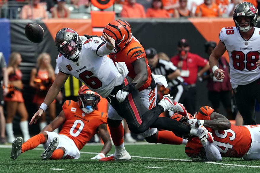 Tampa Bay Buccaneers quarterback Baker Mayfield (6) fumbles as he is hit in the first half of an NFL football game against the Cincinnati Bengals Sunday, Sept. 13, 2026, in Cincinnati. (AP Photo/Joshua A. Bickel)
