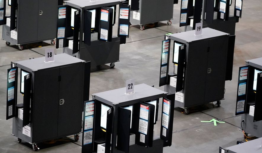 Voting machines fill the floor for early voting at State Farm Arena, Oct. 12, 2020, in Atlanta. (AP Photo/Brynn Anderson, File)