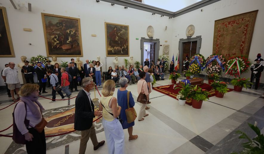 People arrive to pay their tribute to Emma Bonino, who rose to political prominence in the 1970s campaigning to legalize abortion in heavily Roman Catholic Italy, during her lying in state in Rome's City Hall, Sunday, Sept. 13, 2026. (AP Photo/Andrew Medichini)