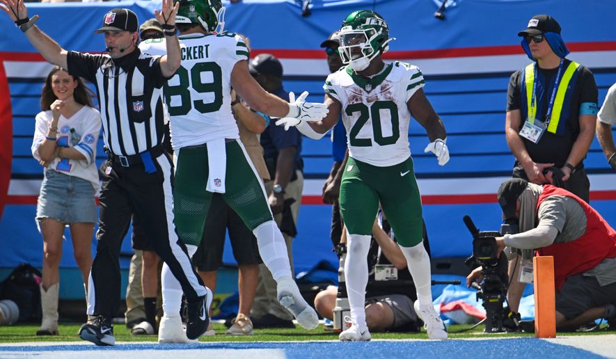New York Jets running back Breece Hall (20) celebrates with teammate tight end Jeremy Ruckert (89) after scoring a touchdown during the second half of an NFL football game against the Tennessee Titans, Sunday, Sept. 13, 2026, in Nashville, Tenn. (AP Photo/John Amis)