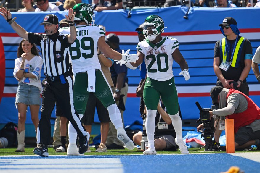 New York Jets running back Breece Hall (20) celebrates with teammate tight end Jeremy Ruckert (89) after scoring a touchdown during the second half of an NFL football game against the Tennessee Titans, Sunday, Sept. 13, 2026, in Nashville, Tenn. (AP Photo/John Amis)